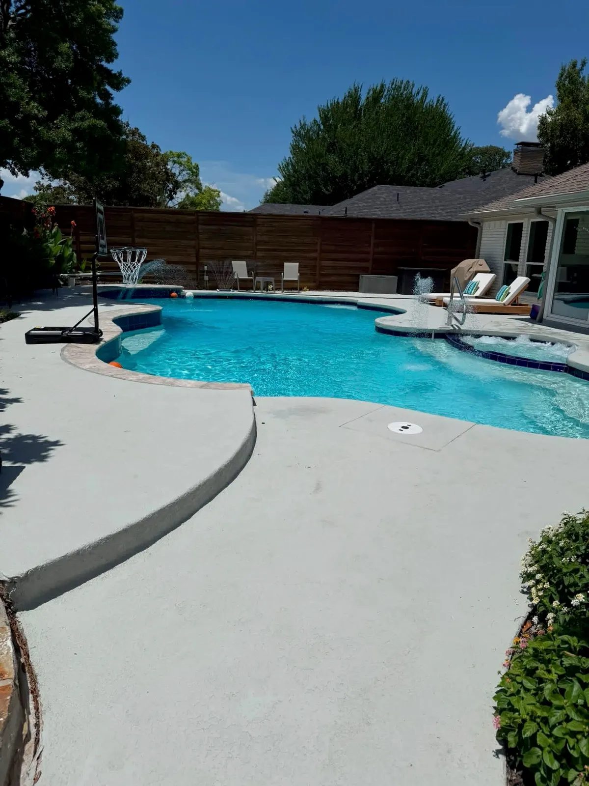 A backyard pool and spa we worked on: clear water, jets running and the spa spilling over