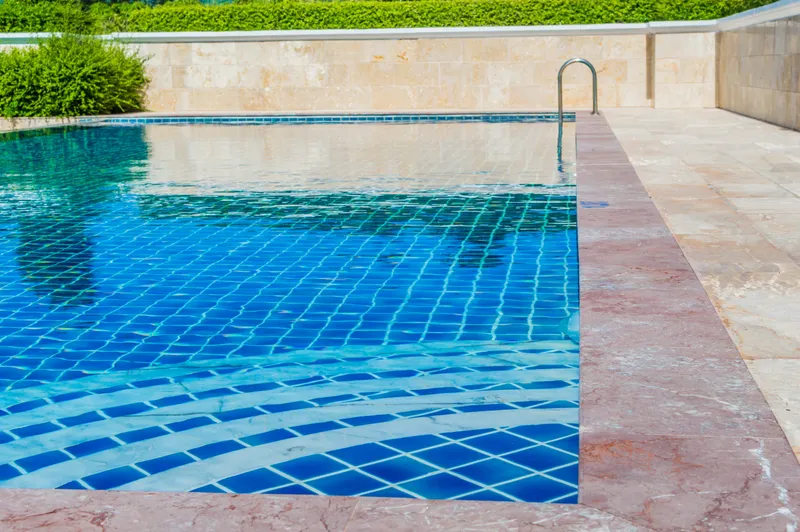 Pool water sitting right at the waterline tile